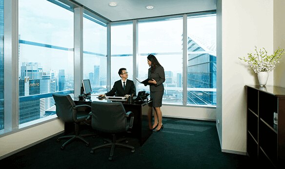 Two professionals in a serviced office at the Marina Bay Financial Centre