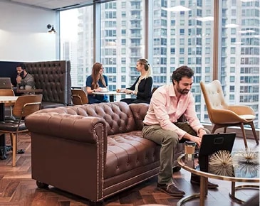 Servcorp coworking lounge with city views, designed for productivity, networking, and flexible work in a premium setting.