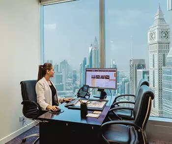 Prestigious serviced offices in Emirates Towers, Dubai were a women is finishing her work.