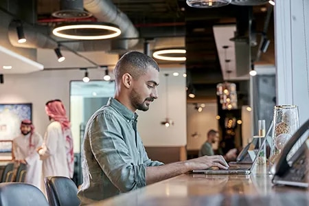A professional focuses on work inside a modern Servcorp coworking space in Saudi Arabia, designed for productivity and flexibility.