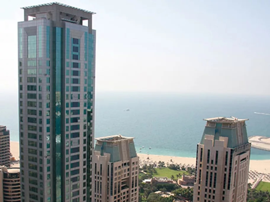 Al Habtoor Business Tower in Dubai Marina, rising elegantly near the coastline with panoramic views of the Arabian Gulf and surrounding high-rises.