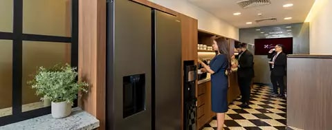 Fully stocked kitchen in Emirates Towers, Dubai, were people are getting some refreshments 