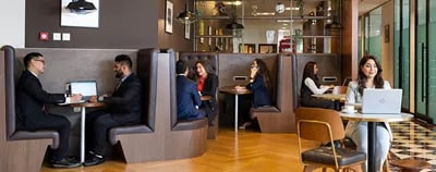 Modern coworking space in Emirates Towers, Dubai, were everyone is sitting and working 