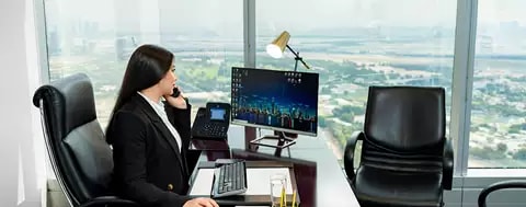 Fully equipped serviced office in Emirates Towers, Dubai were a women is sitting in her own office working 