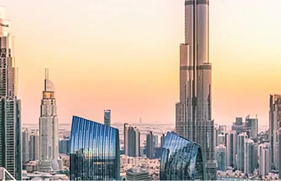 A stunning sunset view of Downtown Dubai with the Burj Khalifa rising above the skyline